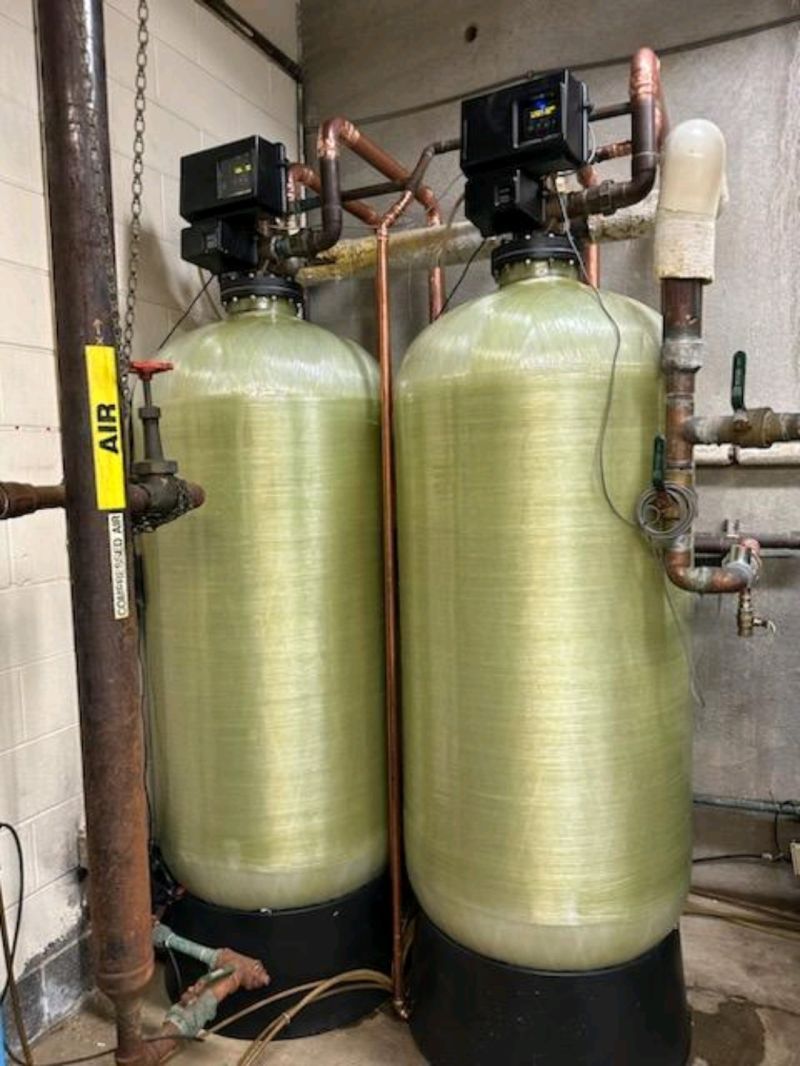 Twin water softener tanks with new control valves, fresh resin, and copper manifold piping, a Hoffman Soft Water upgrade